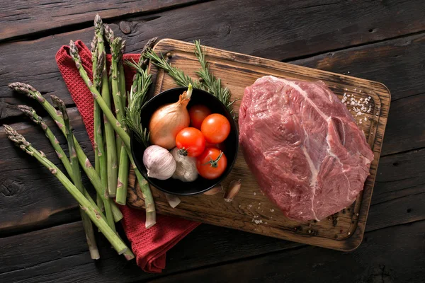 Beef tenderloin with vegetables on kitchen board close up — Stock Photo, Image
