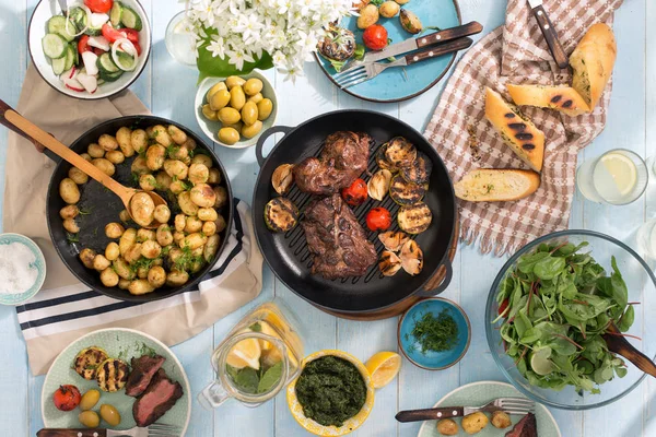 Mesa de jantar com bife grelhado, legumes, batatas, salada, sn — Fotografia de Stock