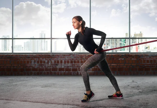 Donna in palestra che fa esercizio con la gomma sportiva — Foto Stock