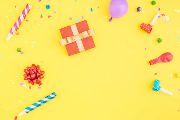 Rode geschenkdoos met diverse partij confetti en ballonnen — Stockfoto