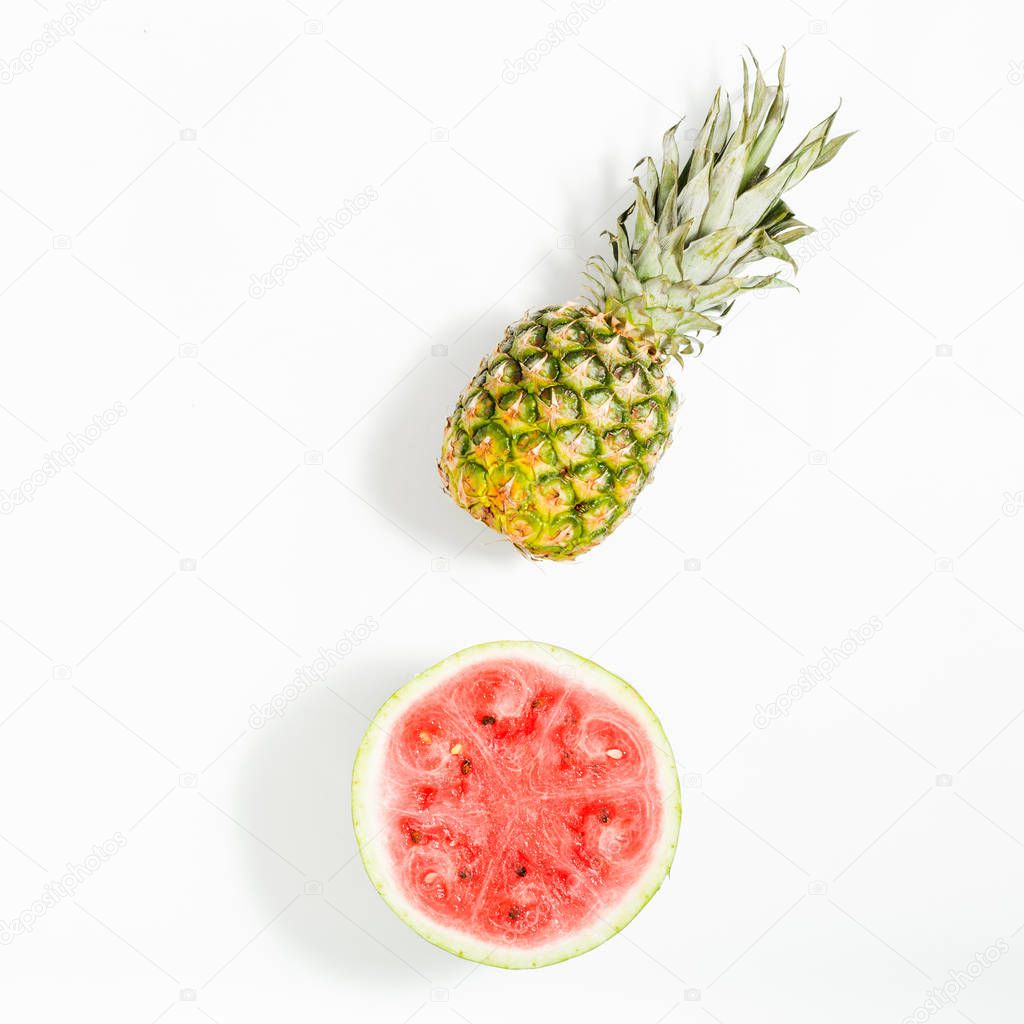 Whole pineapple and sliced watermelon on white background, top v
