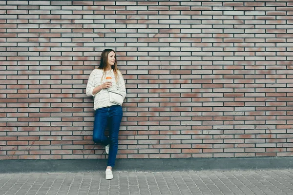 Trendy Girl Standing at the Brick Wall — стоковое фото