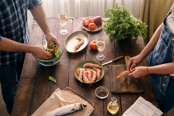 Pareja cocinando juntos la cena de camarones — Foto de Stock