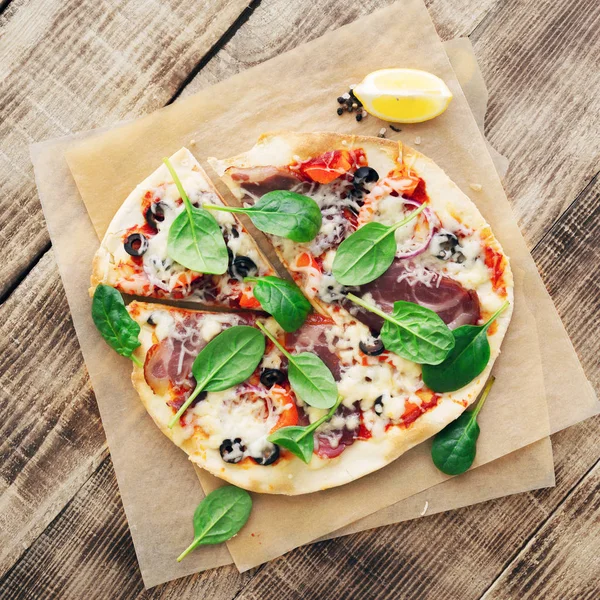 Italian pizza on wooden table close up, top view — Stock Photo, Image