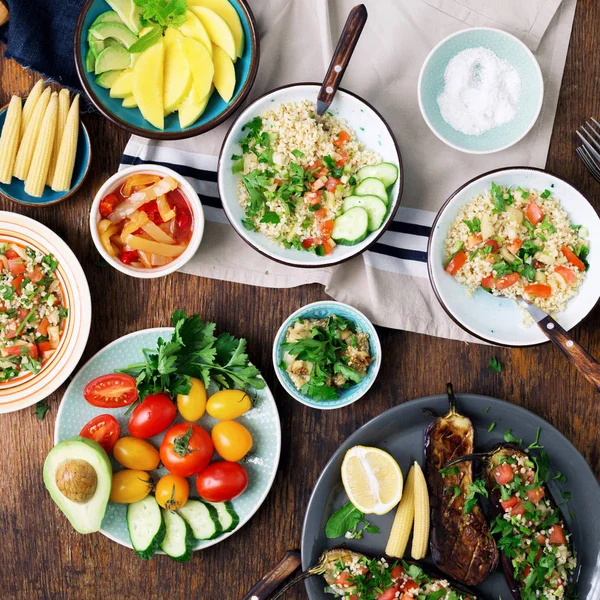 Vegetarian salad, vegetables, stuffed eggplant, fruit and snacks — Stock Photo, Image