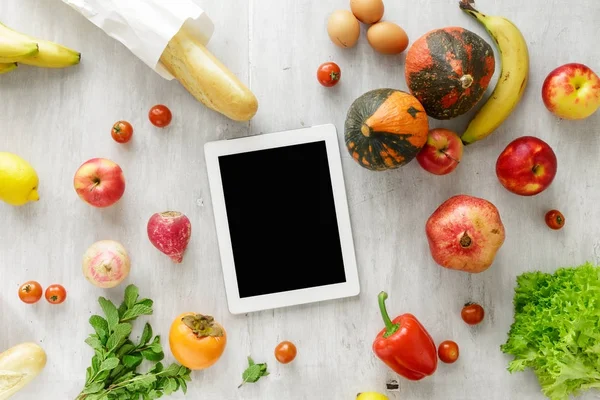 Tablet ile çiğ gıda, Beyaz ahşap arka plan üzerinde ayarlayın. Sağlıklı gıda kavramı, üstten görünüm
