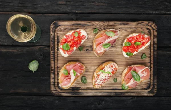 Set Different Bruschettas Wooden Board Dark Background Glass White Wine — Stock Photo, Image