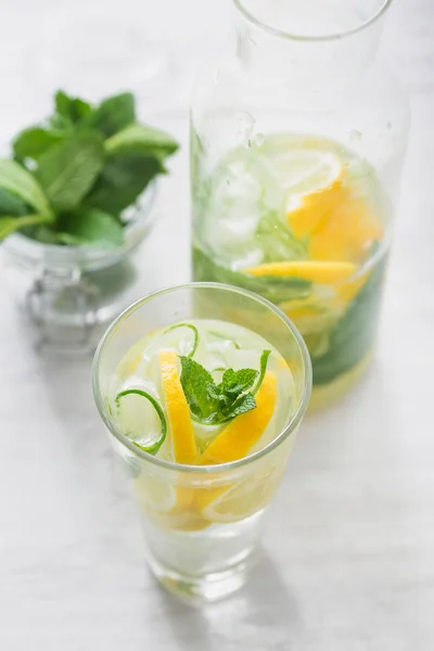 Glass of detox water with cucumber, lemon and mint top view