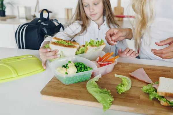 Mother daughter preparing school snack lunch home kitchen — Stock Photo, Image