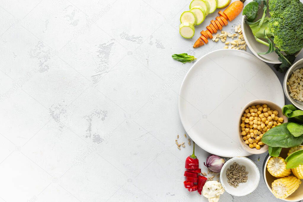 Empty plate with vegetarian food. Fresh ingredients for cooking vegan  meal top view