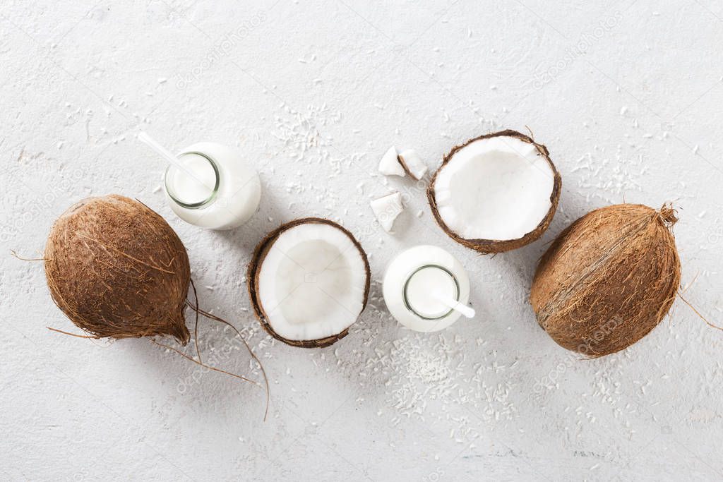 Coconut milk in bottles on white background top view. Healthy eating concept Top view