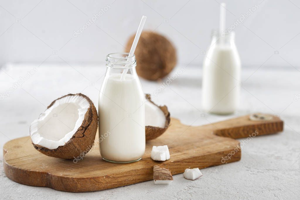 Coconut kefir in bottles on white background. Healthy eating concept. Fermented drinks