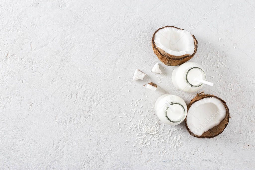 Coconut kefir in bottles on white background top view. Vegan non dairy healthy or fermented drink. Healthy eating concept Top view