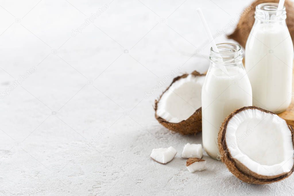 Coconut kefir in bottles on light background. Vegan non dairy healthy or fermented drink. Healthy eating concept