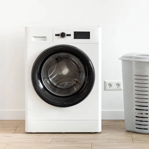 Washing machine with laundry basket in the home laundry room