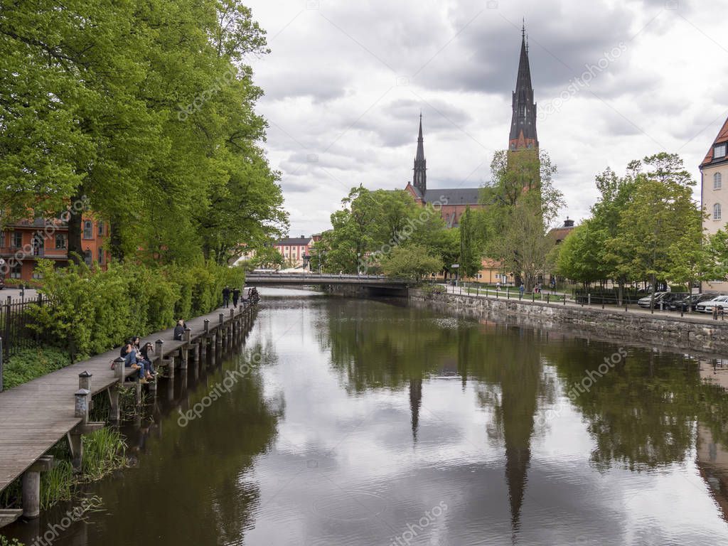 view of the church in Uppsala city center in Sweden, Uppsala cathedral reflecting in the water surface