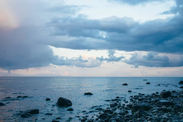 Vista panorámica de la costa del mar con piedras y nubes de trueno — Foto de Stock