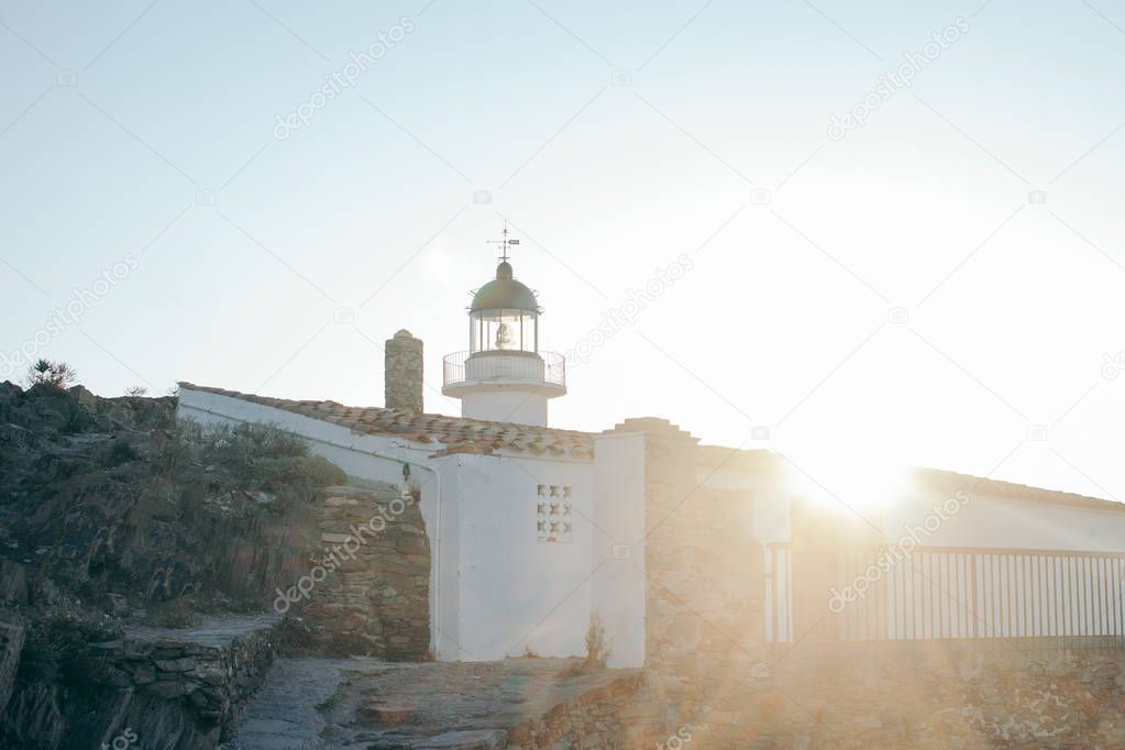 lighthouse by the sea at sunrise