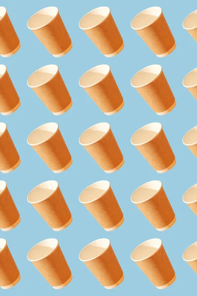 Paper disposable cups pattern on a blue background.