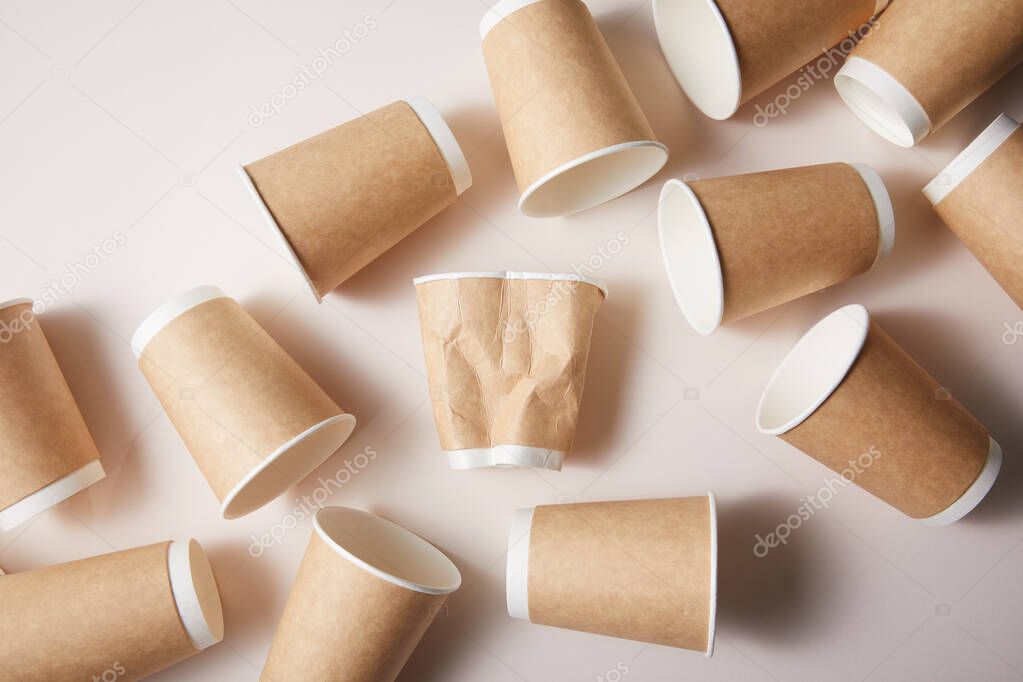 isolated paper cups on brown paper background