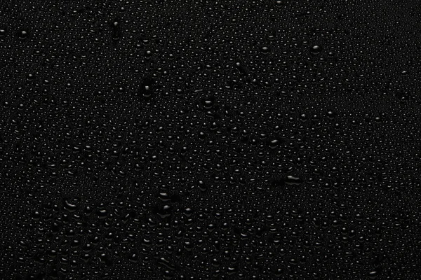rain drops on black background top view