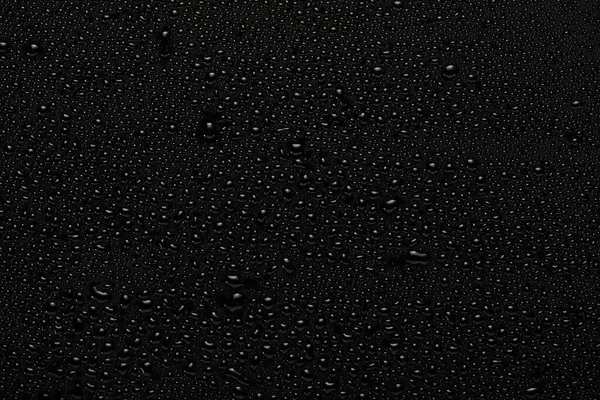 rain drops on black background top view