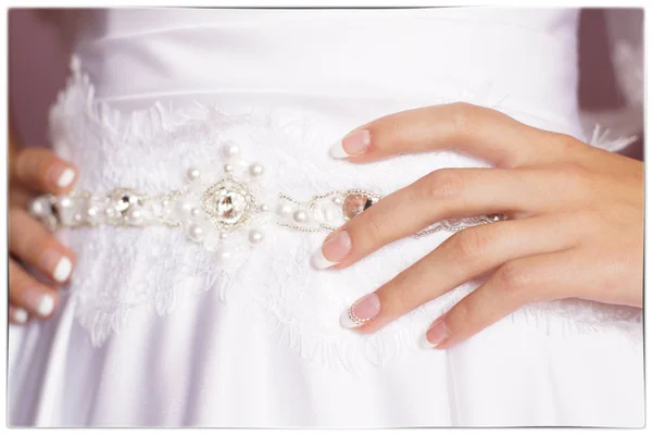 The bride put her hands on his belt, beautiful manicure — Stock Photo, Image