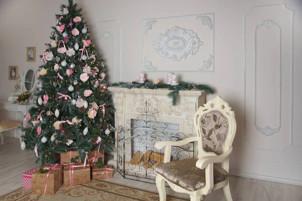 Interior da sala de estar com uma lareira, decorada para o Ano Novo com uma grande árvore de Natal e muitos presentes — Fotografia de Stock