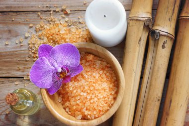 Spa arka plan bambu, banyo tuzu, ahşap bir masa üzerine masaj yağı ve beyaz mum