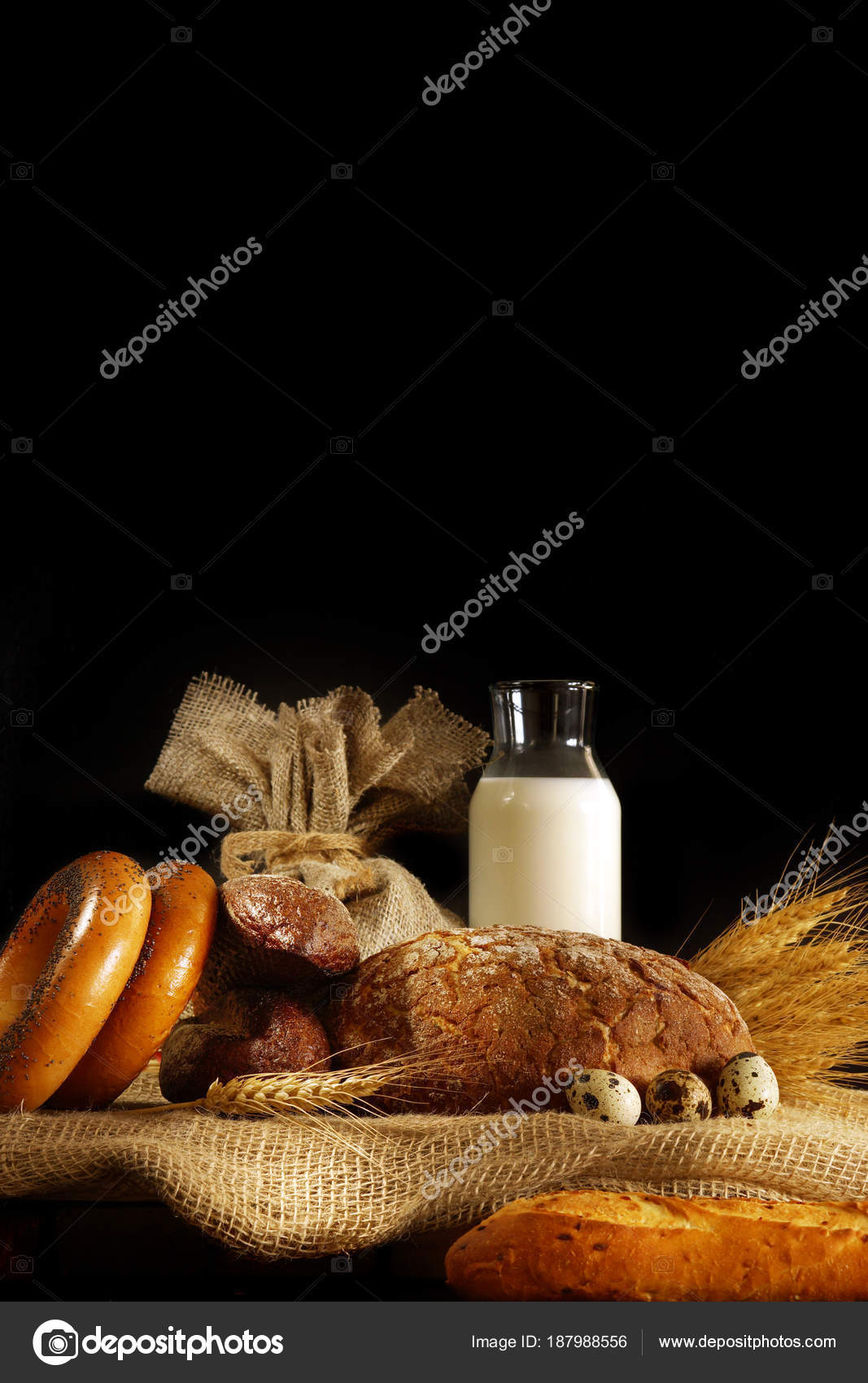 натюрморт с яйцами и молоком. depositphotos 187988556 stock photo vertical still life on a. натюрморт с яйцами и молоком фото. натюрморт с яйцами и молоком-depositphotos 187988556 stock photo vertical still life on a. картинка натюрморт с яйцами и молоком. картинка depositphotos 187988556 stock photo vertical still life on a. Стакан молока, буханка и сноп на черном фоне, с местом для текста