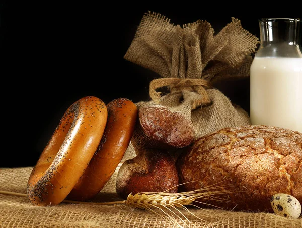 Хлеб, шипы и яйца в натюрморте на темном фоне — стоковое фото