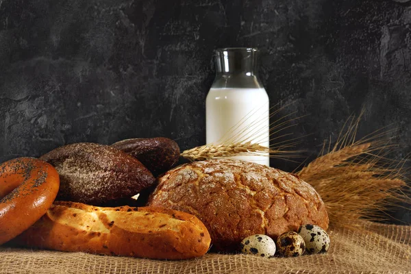 натюрморт с яйцами и молоком. depositphotos 195233474 stock photo freshly baked bread with a. натюрморт с яйцами и молоком фото. натюрморт с яйцами и молоком-depositphotos 195233474 stock photo freshly baked bread with a. картинка натюрморт с яйцами и молоком. картинка depositphotos 195233474 stock photo freshly baked bread with a. Стакан молока, буханка и сноп на черном фоне, с местом для текста