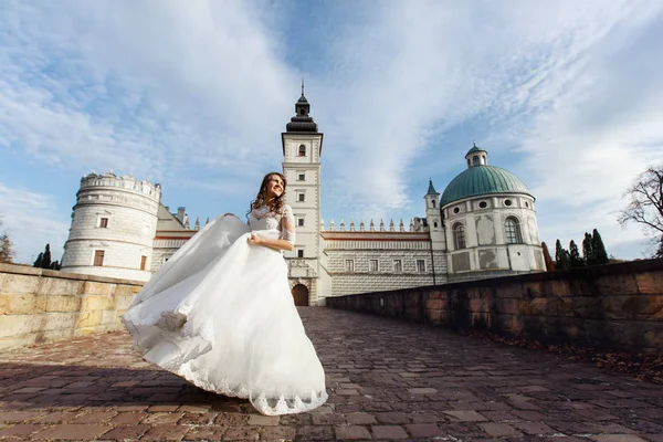 Braut in prachtvollem Kleid am alten Schloss — Stockfoto