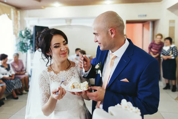 Recém-casados degustação bolo de casamento — Fotografia de Stock