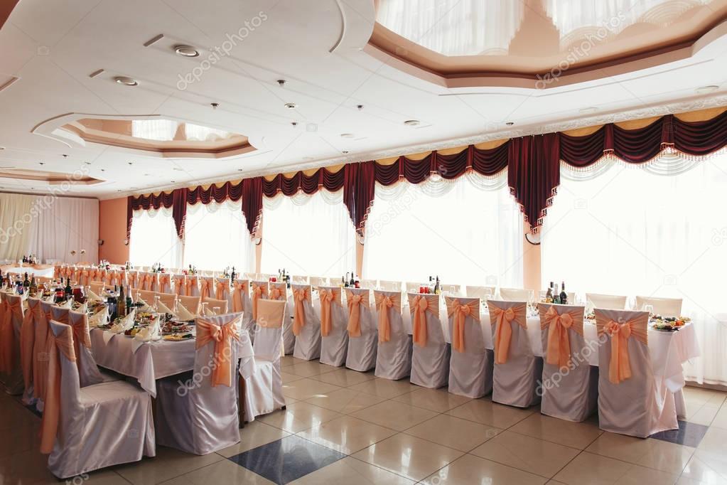 Cozy restaurant hall decorated for wedding