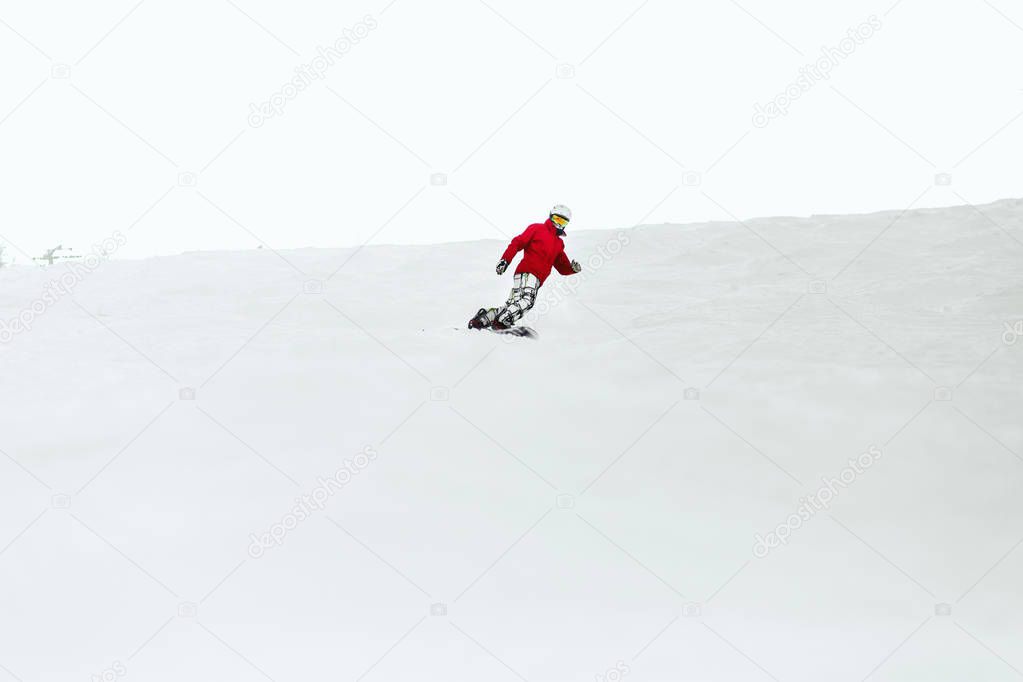 Snowboarder enjoys snow in mountains