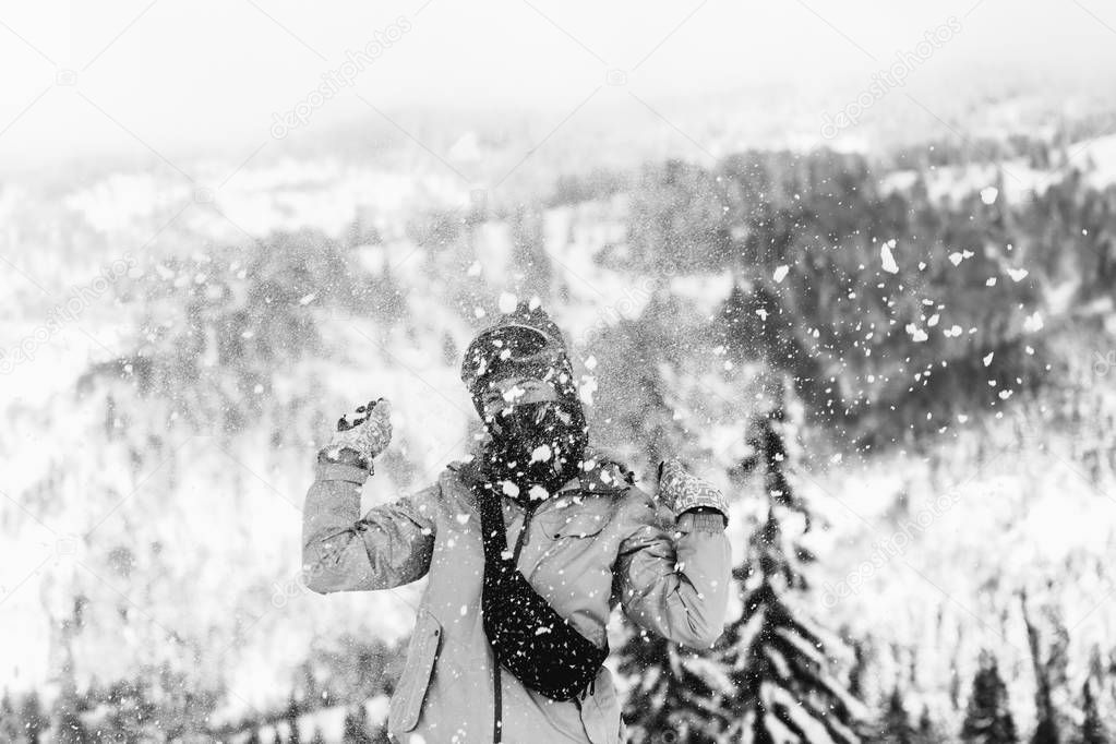 Snowboarder woman in snowy mountains