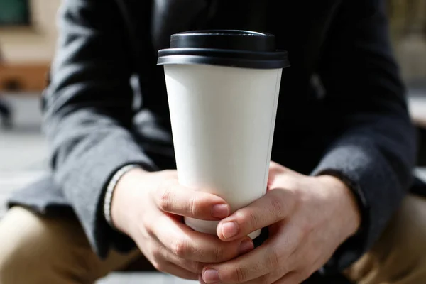 Man holding coffee to-go