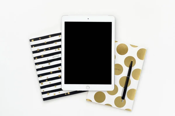 Flat lay photo of office white desk with tablet and gold notebook copy space background — Stock Photo, Image