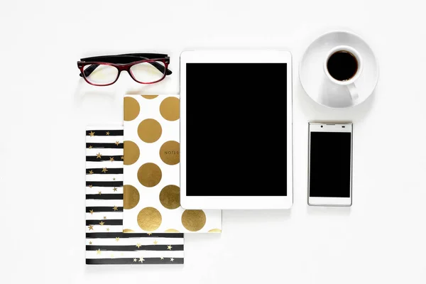 办公桌上白色背景触摸垫平板电脑小工具手机与金时尚书籍，顶视图 — 图库照片