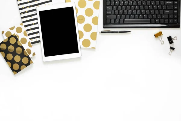 Flat lay photo of office white desk with tablet, keyboard and gold notebook copy space background — Stock Photo, Image