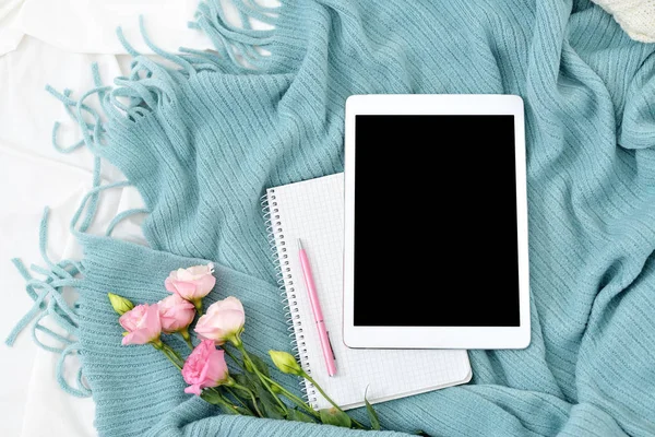 Flat lay tablet, phone, cup of coffee and flowers on white blanket with turquoise plaid — Stock Photo, Image