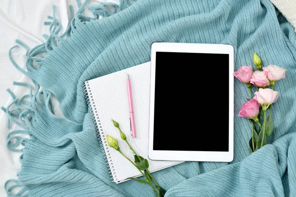 Flat lay tablet, phone, cup of coffee and flowers on white blanket with turquoise plaid — Stock Photo, Image