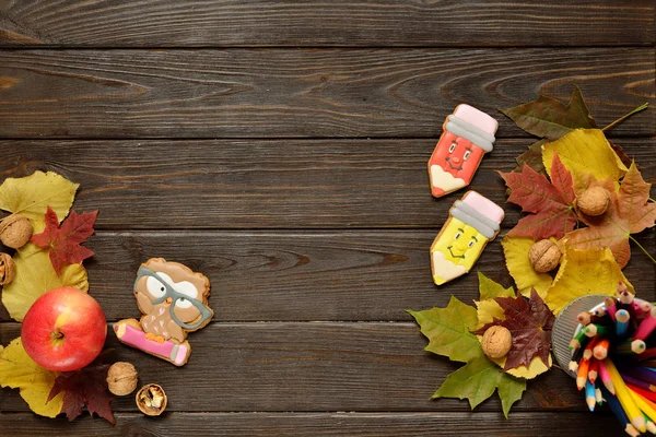 Geri okul kavramı ve arka plan için renkli kalemler, kırmızı appple gingerbread ahşap tablo