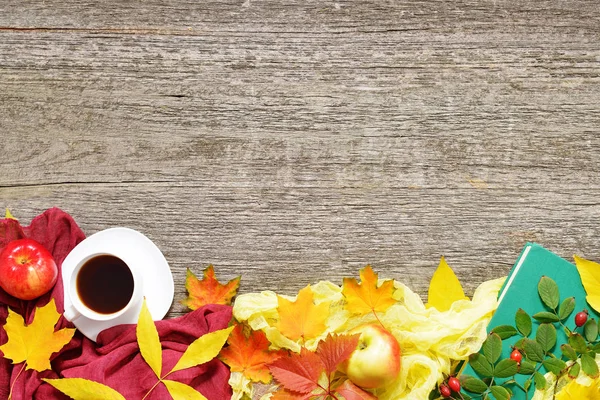 Autumn set of red, green and yellow leaves, apples with cup of coffee or tea with books on vintage background. — Stock Photo, Image