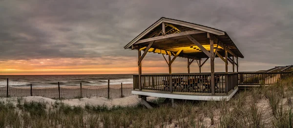 Sunrise over the Atlantic Ocean near a pavilion in Beach Haven, NJ