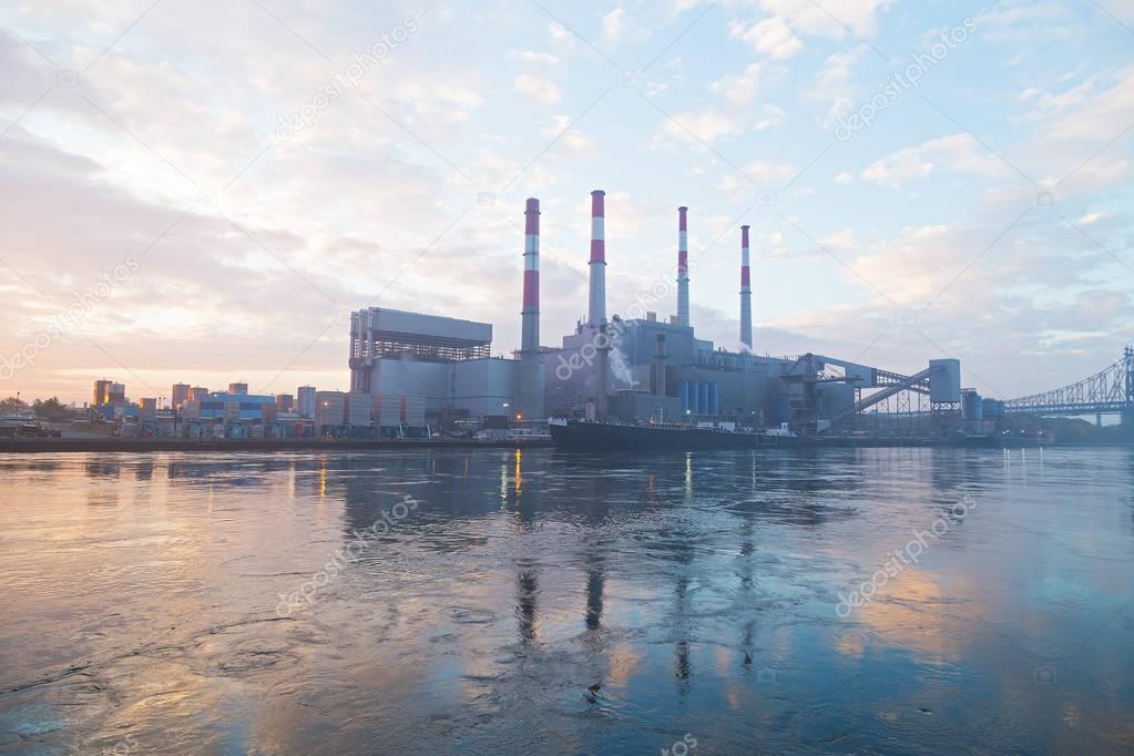 New York city infrastructure on the shore of East River at dawn. 