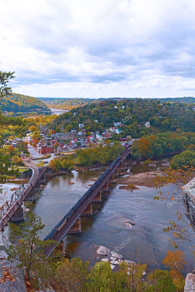 Aerial view on Harpers Ferry historic town and the rail bridge from the park overlook. Railroad bridge, mountains and river banks in fall, West Virginia, USA.