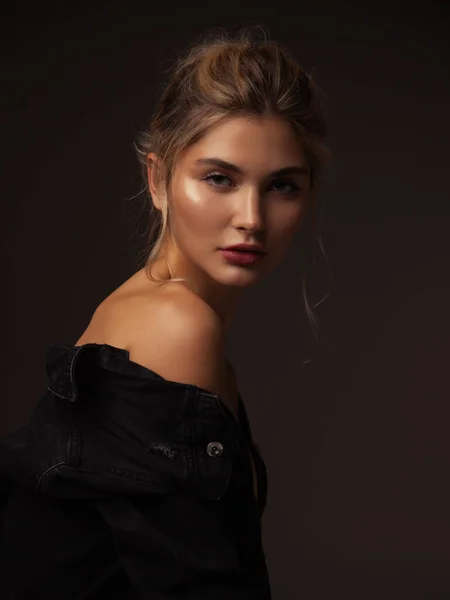 Portrait of young fashion model with volume ponytail hairstyle. Natural make up. closed eyes. Healthy glowing skin. beautiful blonde woman with elegant hairstyle on black background. Volume hair.