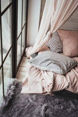 cozy place with pillows near window 